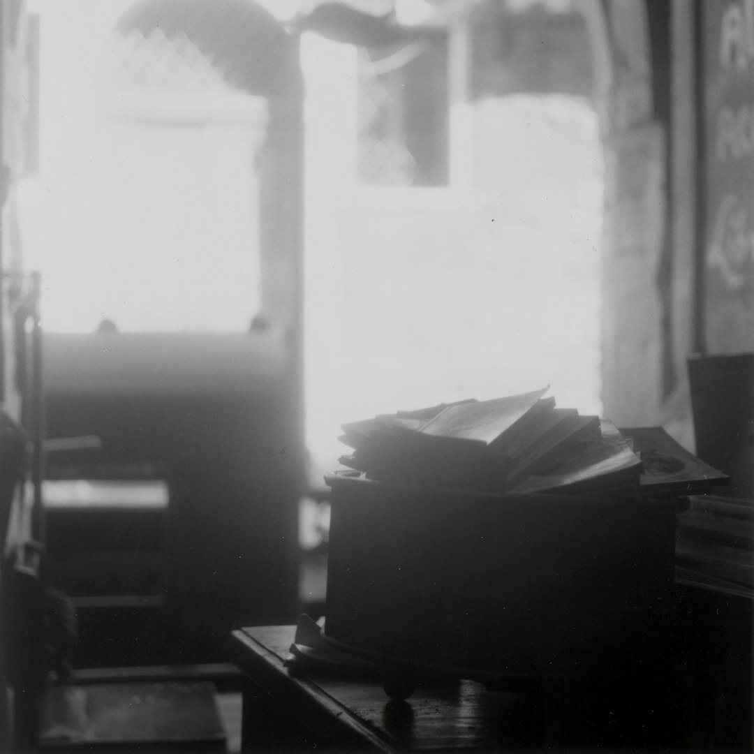 Close-up of a vintage black typewriter with a blank sheet of paper