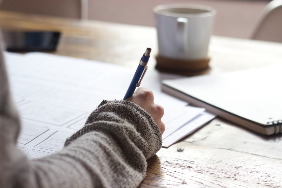 writer at desk with notes