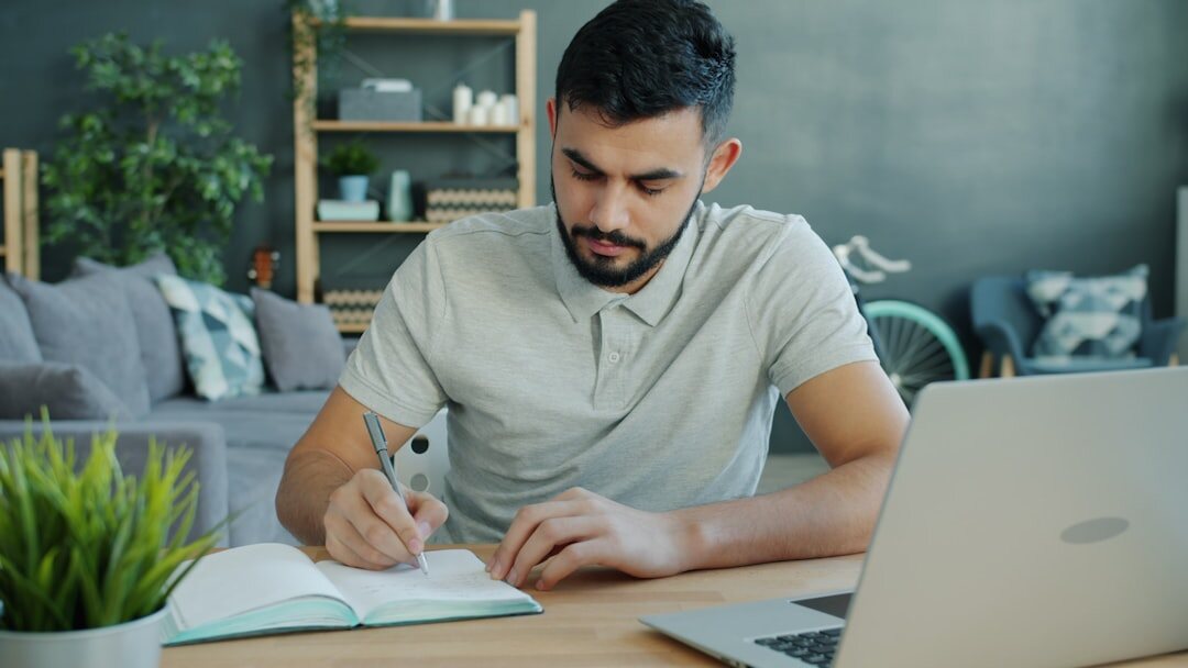 writer at desk with notebook